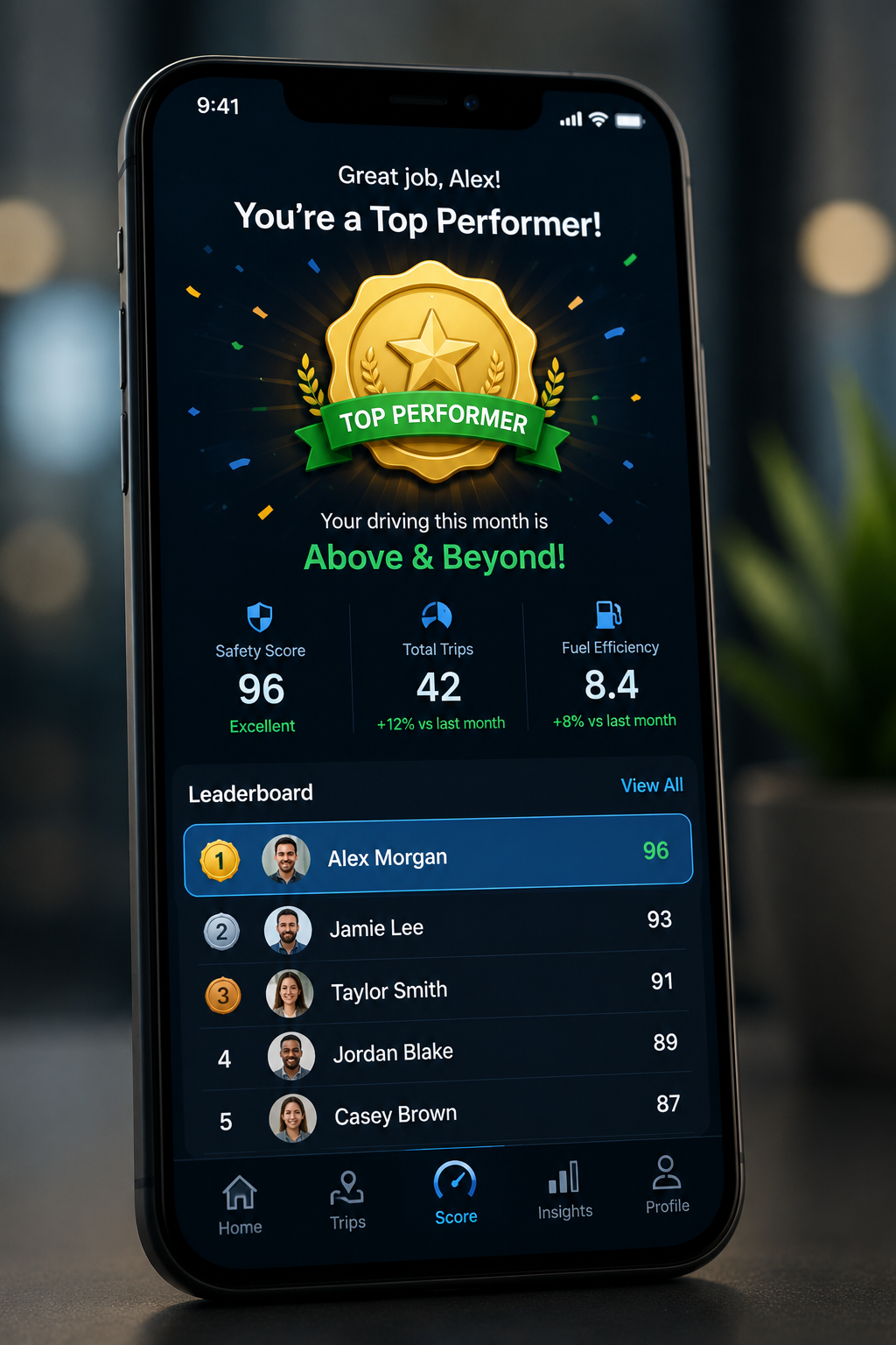 Phone showing a Top Performer badge with a leaderboard of drivers and their safety scores